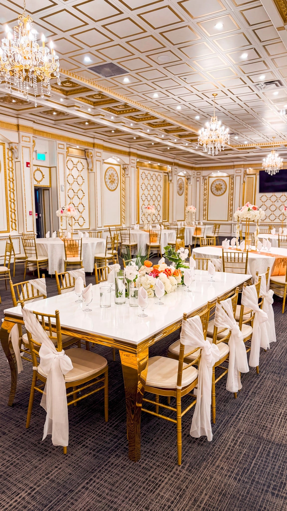 Long banquet table dressed with candles and greenery